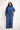 Woman wearing a blue turtleneck and striped pants on a white background