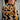 Person wearing a patterned shirt with geometric design in brown, black, and beige.