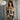 Woman wearing a patterned outfit against a textured background.